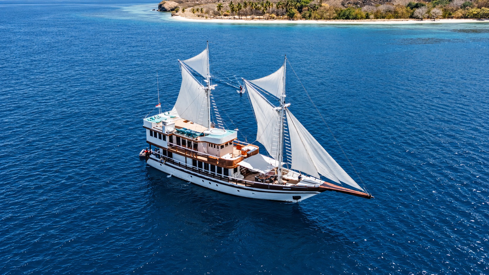 The M/V KAYRA at sea, sails hoisted